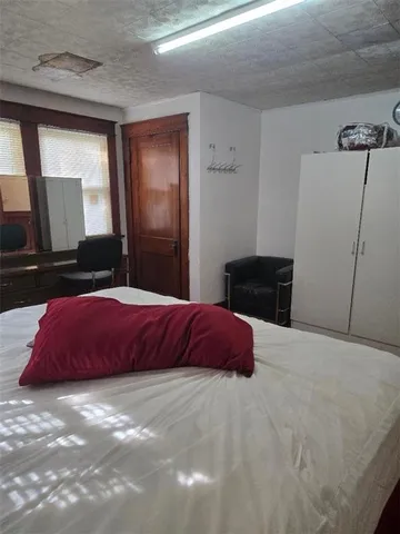 a bedroom with a bed and dresser