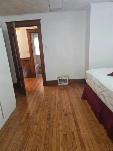 a view of a room with wooden floor and a sink