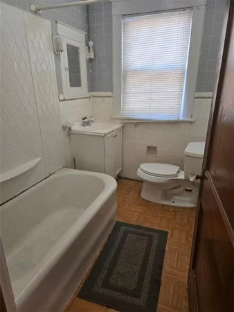 a bathroom with a sink a toilet and mirror