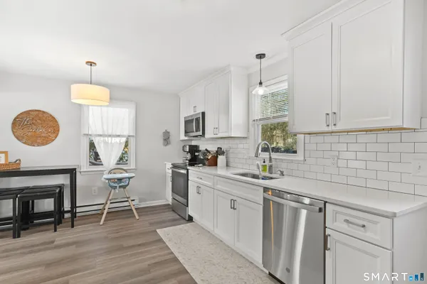 a kitchen with a sink cabinets and window