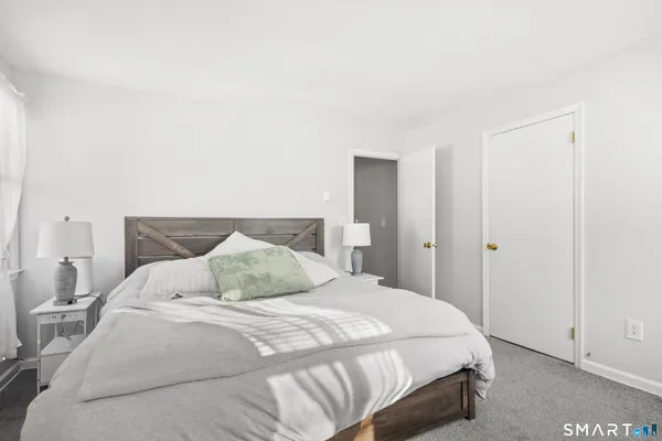 a bedroom with a bed and a night stand