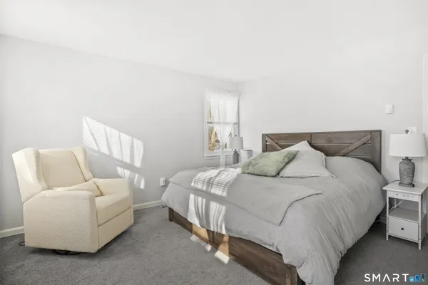 a bedroom with a bed and lamp