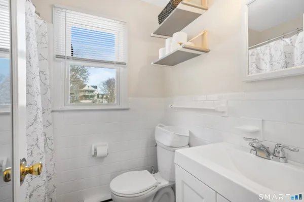 a bathroom with a toilet a sink and a shower