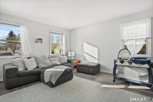 a living room with furniture a table and a large window