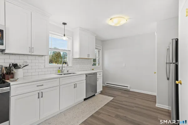 a kitchen with a sink cabinets and window