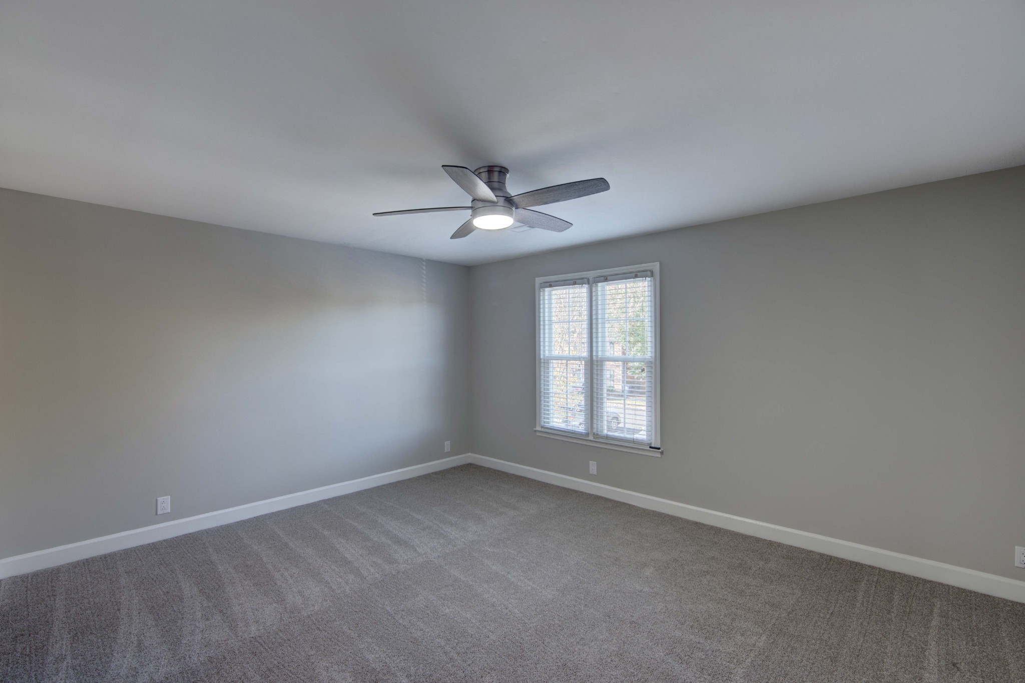 1129 West Main Street, Unit 4 Franklin, TN 37064 - Photo 18 of 27 an empty room with a window and a ceiling fan