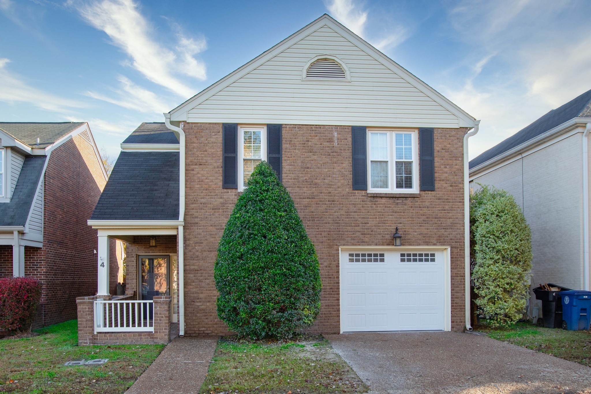 1129 West Main Street, Unit 4 Franklin, TN 37064 - Photo 2 of 27 a view of a brick house with a yard plants and large tree