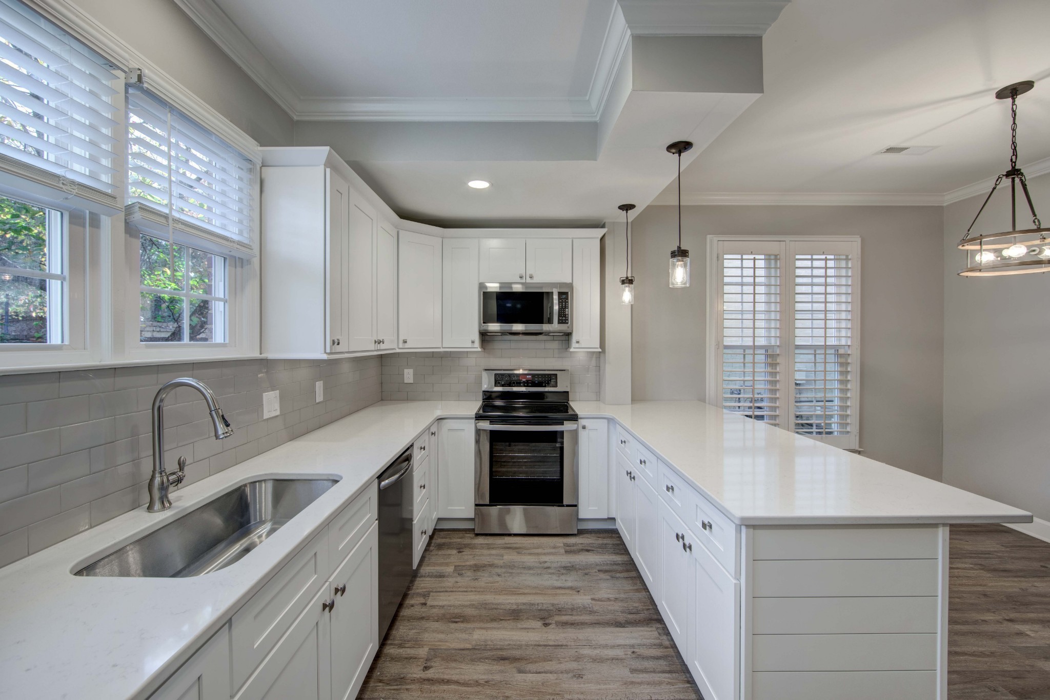 1129 West Main Street, Unit 4 Franklin, TN 37064 - Photo 5 of 27 a large kitchen with stainless steel appliances granite countertop a sink and dishwasher a stove with wooden floor