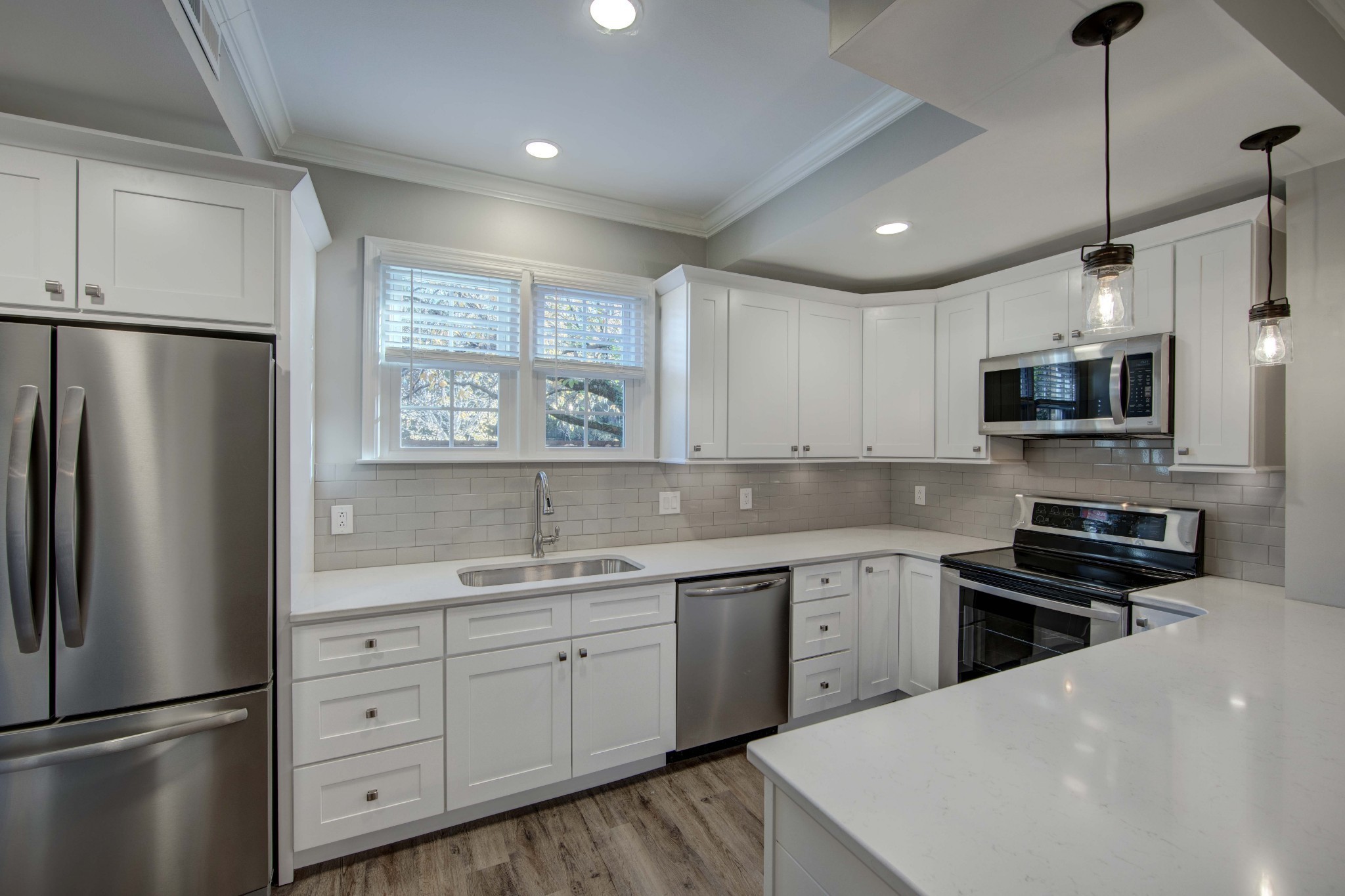 1129 West Main Street, Unit 4 Franklin, TN 37064 - Photo 6 of 27 a kitchen with a refrigerator a sink stainless steel appliances and cabinets