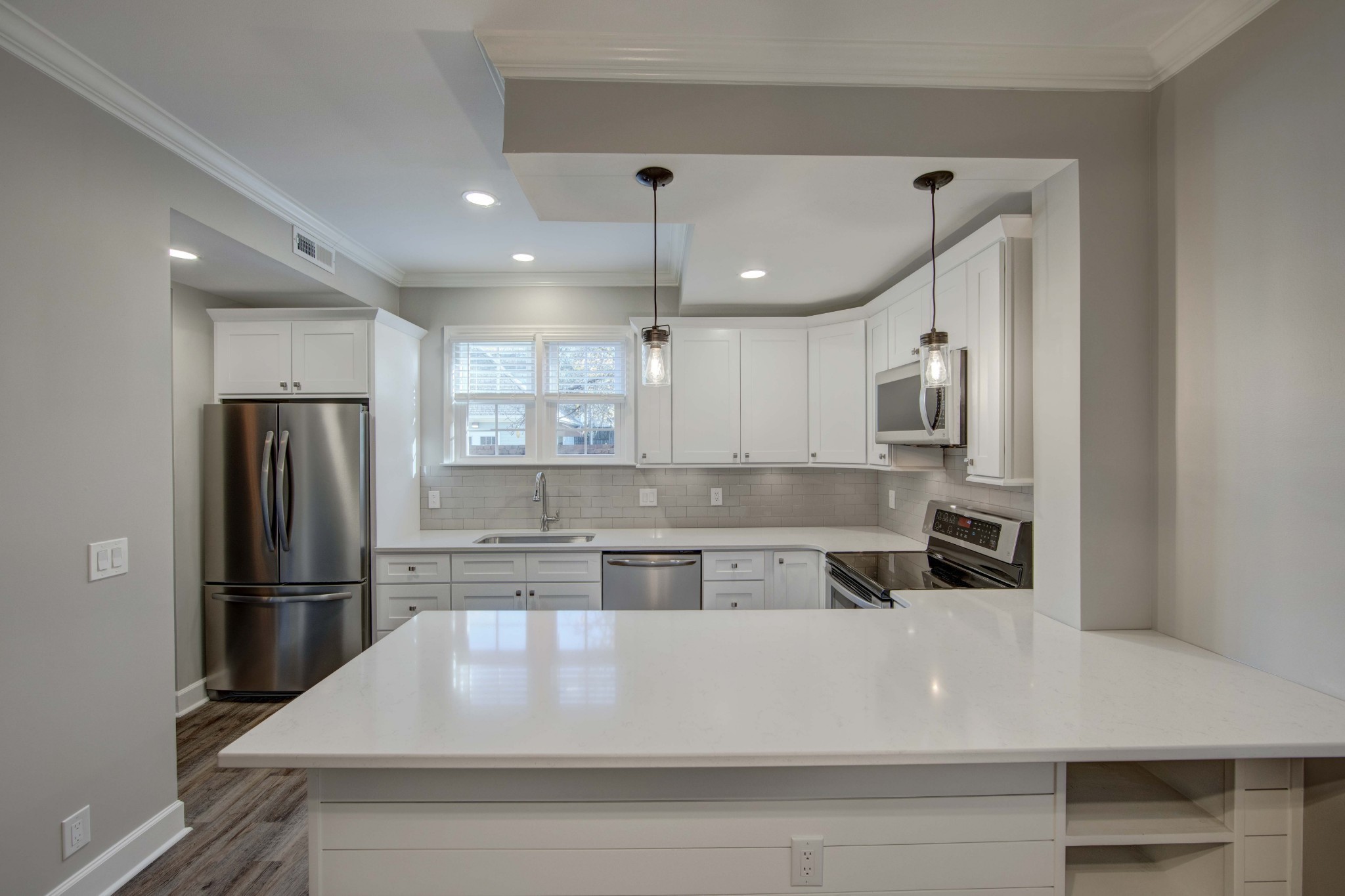 1129 West Main Street, Unit 4 Franklin, TN 37064 - Photo 7 of 27 a kitchen with kitchen island a counter top space a refrigerator and cabinets