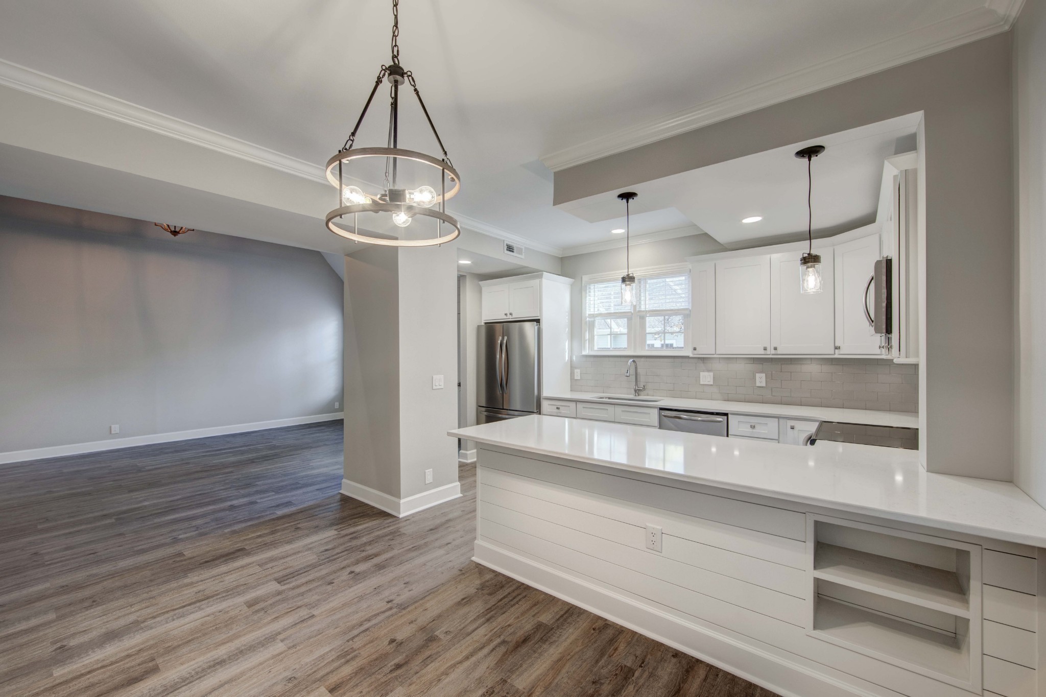 1129 West Main Street, Unit 4 Franklin, TN 37064 - Photo 8 of 27 a large kitchen with stainless steel appliances granite countertop a dishwasher a stove and a chandelier