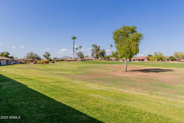 a view of grassy field with benches