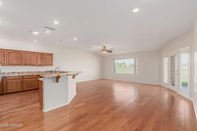 a kitchen with stainless steel appliances granite countertop a sink stove and cabinets