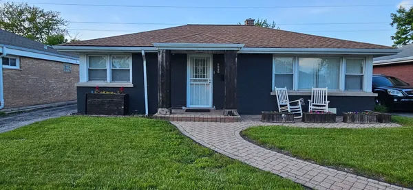 a front view of a house with garden and porch