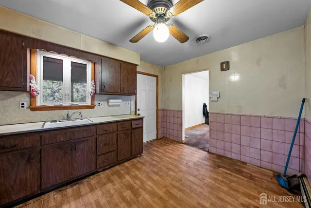 a spacious bathroom with a double vanity sink a mirror and a shower