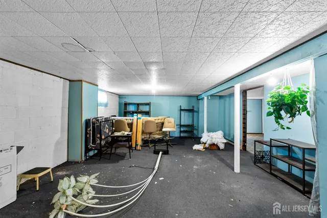 a bedroom with furniture and large windows