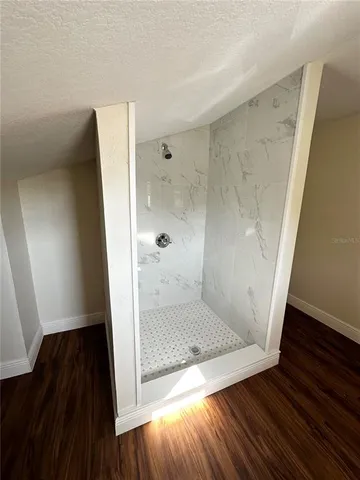 a bathroom with a granite countertop toilet sink and mirror