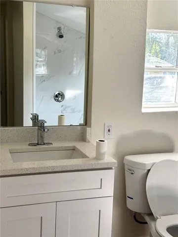 a view of small space with wooden floor and a window