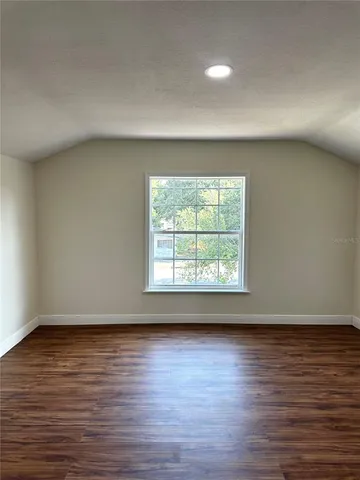a view of an empty room and wooden floor