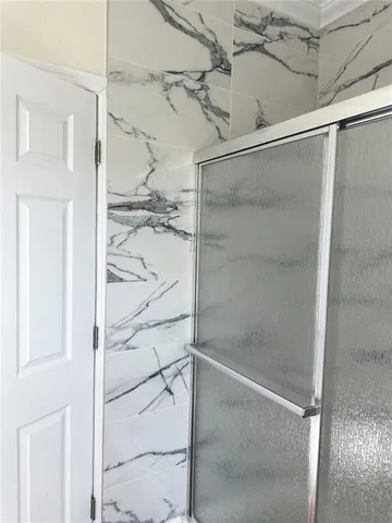 a bathroom with a glass shower door