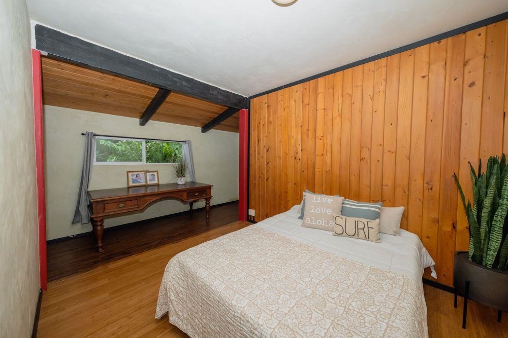 59 Door Of Faith Road Haiku, HI 96708 - Photo 12 of 45 a bedroom with a bed and large window