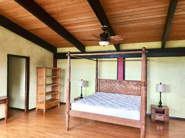 a bedroom with a bed and a mirror