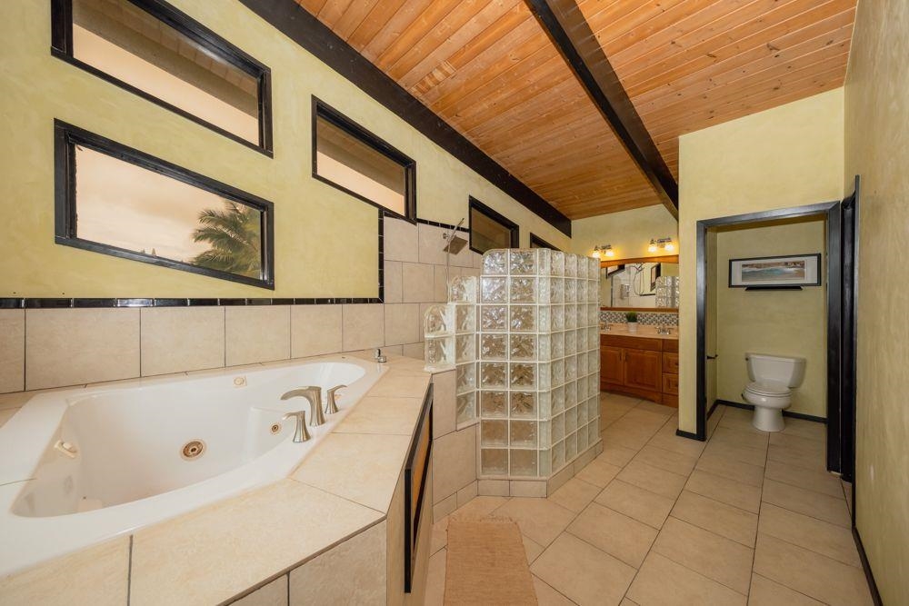 59 Door Of Faith Road Haiku, HI 96708 - Photo 15 of 45 a bathroom with a bathtub and a shower