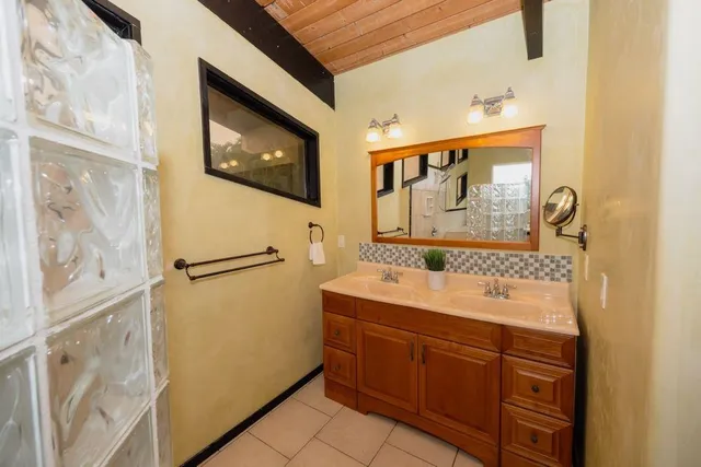 a garden with flowers and wooden fence