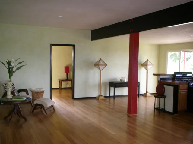 a house with wooden fence in front of it