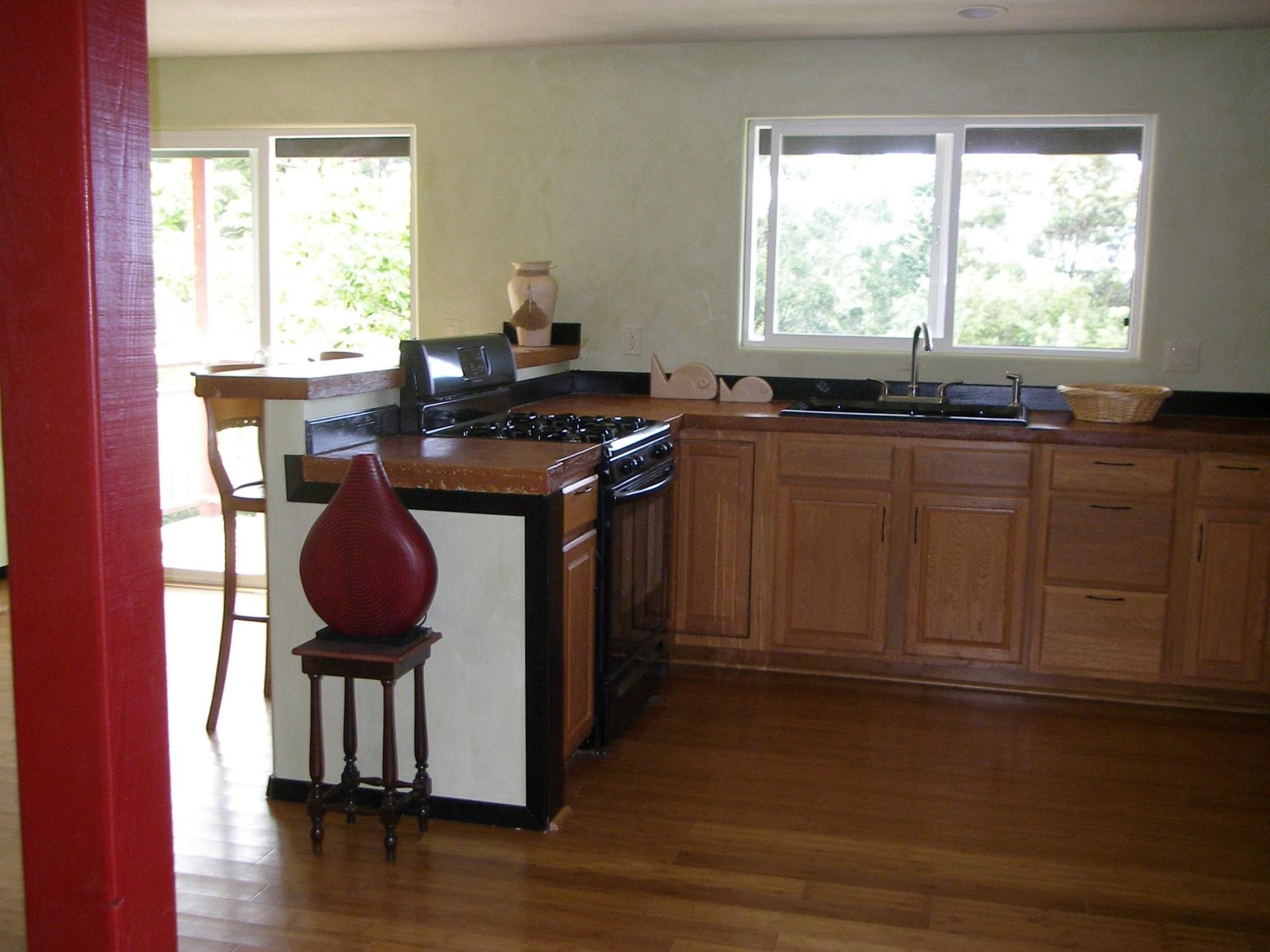 59 Door Of Faith Road Haiku, HI 96708 - Photo 23 of 45 a kitchen with granite countertop a stove a sink and a window