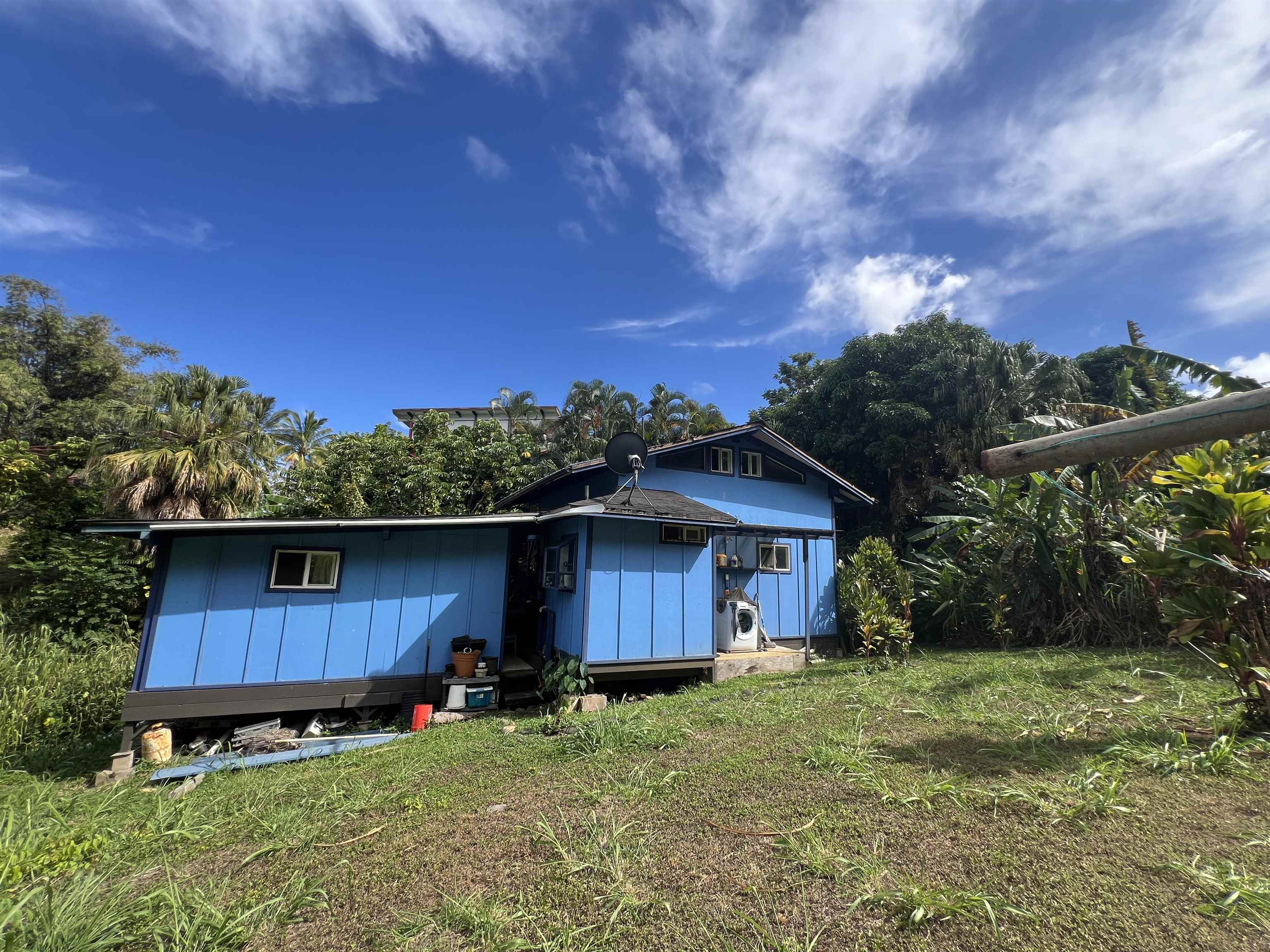 59 Door Of Faith Road Haiku, HI 96708 - Photo 39 of 45 a house with wooden fence in front of it