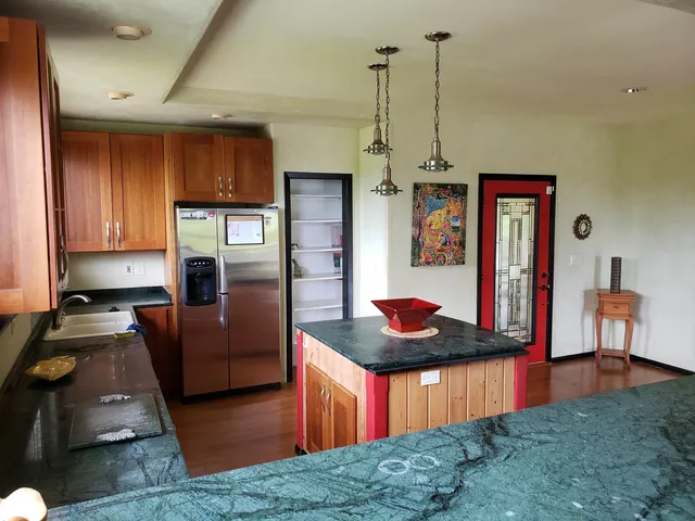 a dining room with wooden floor table and chairs