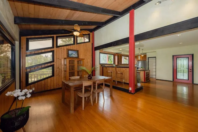 a bedroom with a bed and a wooden floor