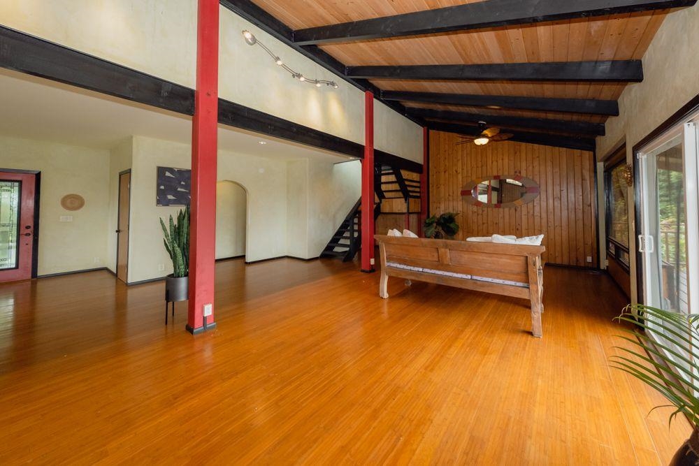 59 Door Of Faith Road Haiku, HI 96708 - Photo 10 of 45 a bedroom with wooden floor and furniture