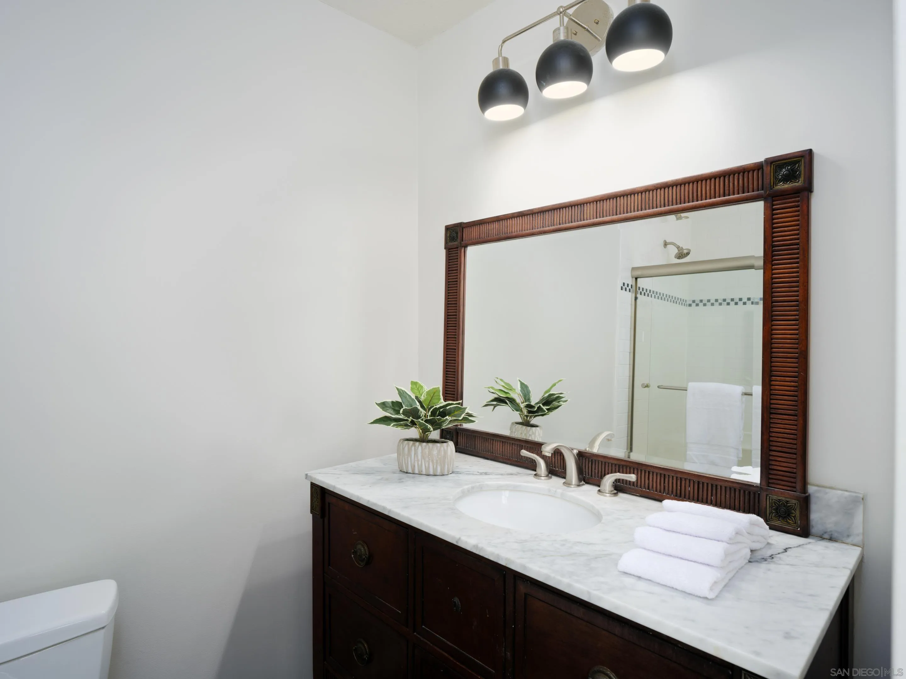 3520 Silvergate Place San Diego, CA 92106 - Photo 21 of 35 a bathroom with a granite countertop sink and a mirror