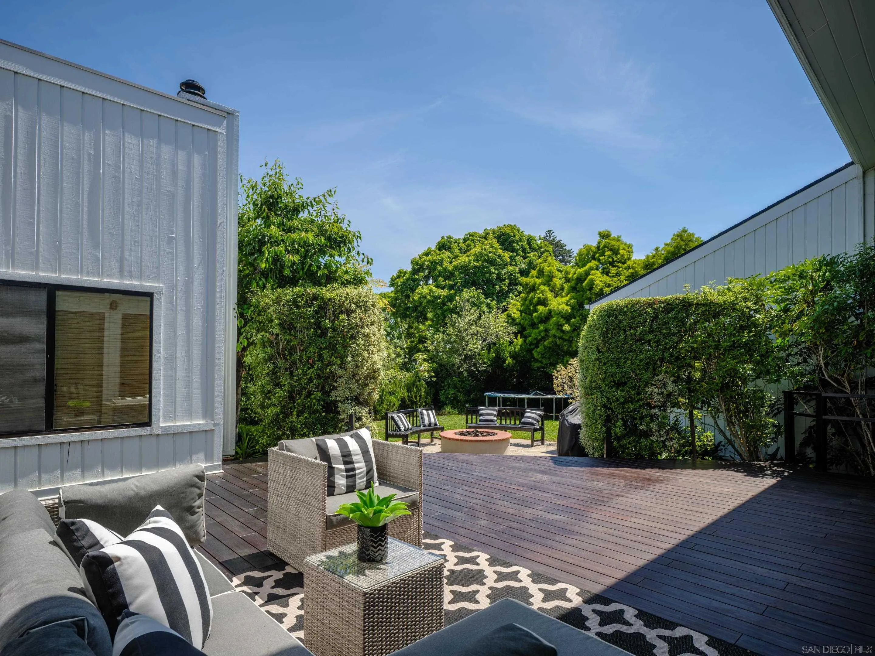 3520 Silvergate Place San Diego, CA 92106 - Photo 28 of 35 a view of a patio with couches and table and chairs with wooden floor and plants
