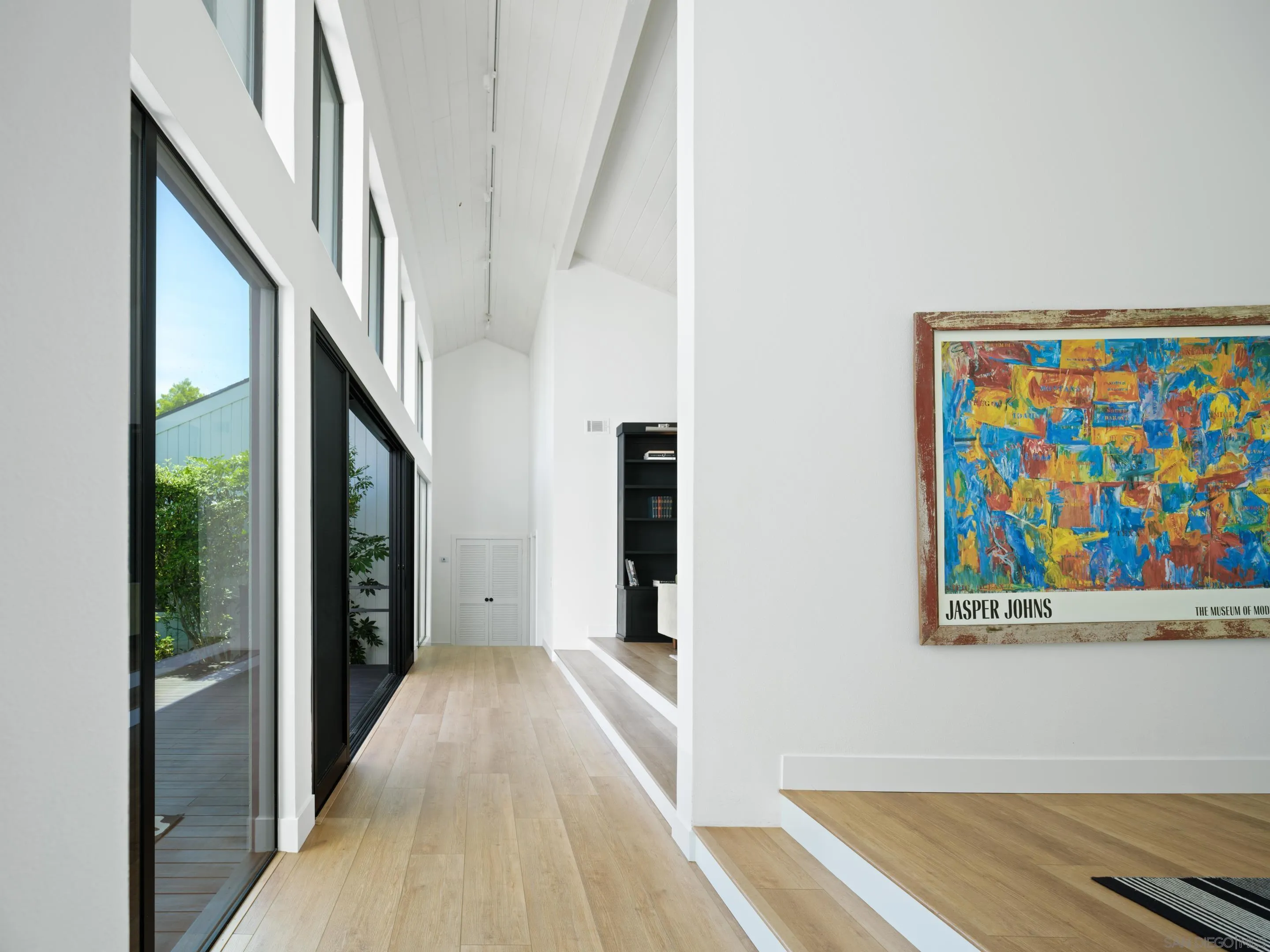 3520 Silvergate Place San Diego, CA 92106 - Photo 7 of 35 a view of a hallway with wooden floor and staircase
