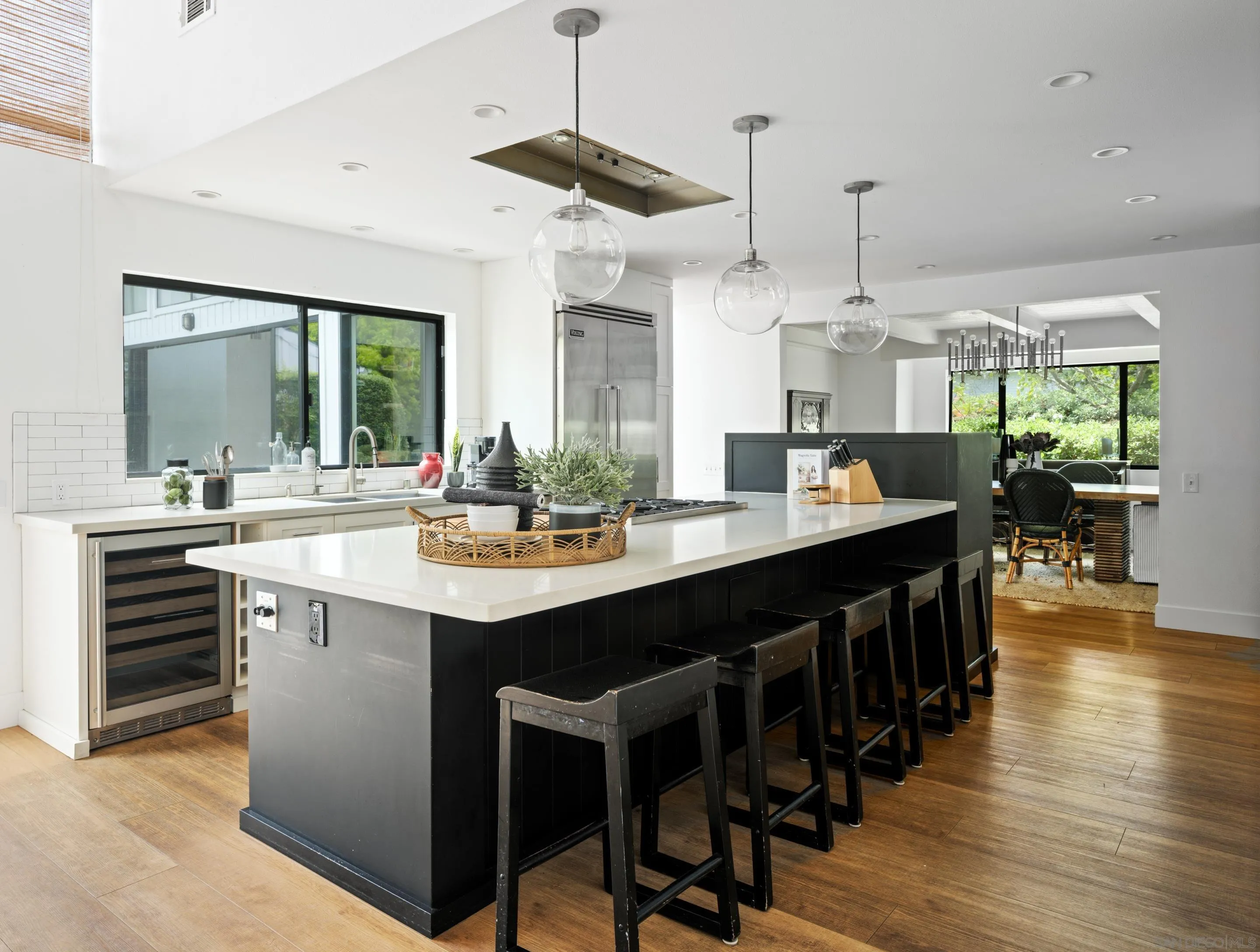 3520 Silvergate Place San Diego, CA 92106 - Photo 10 of 35 a kitchen with kitchen island granite countertop a sink cabinets and wooden floor