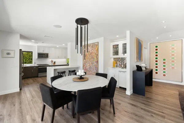a view of a dining room with furniture and wooden floor