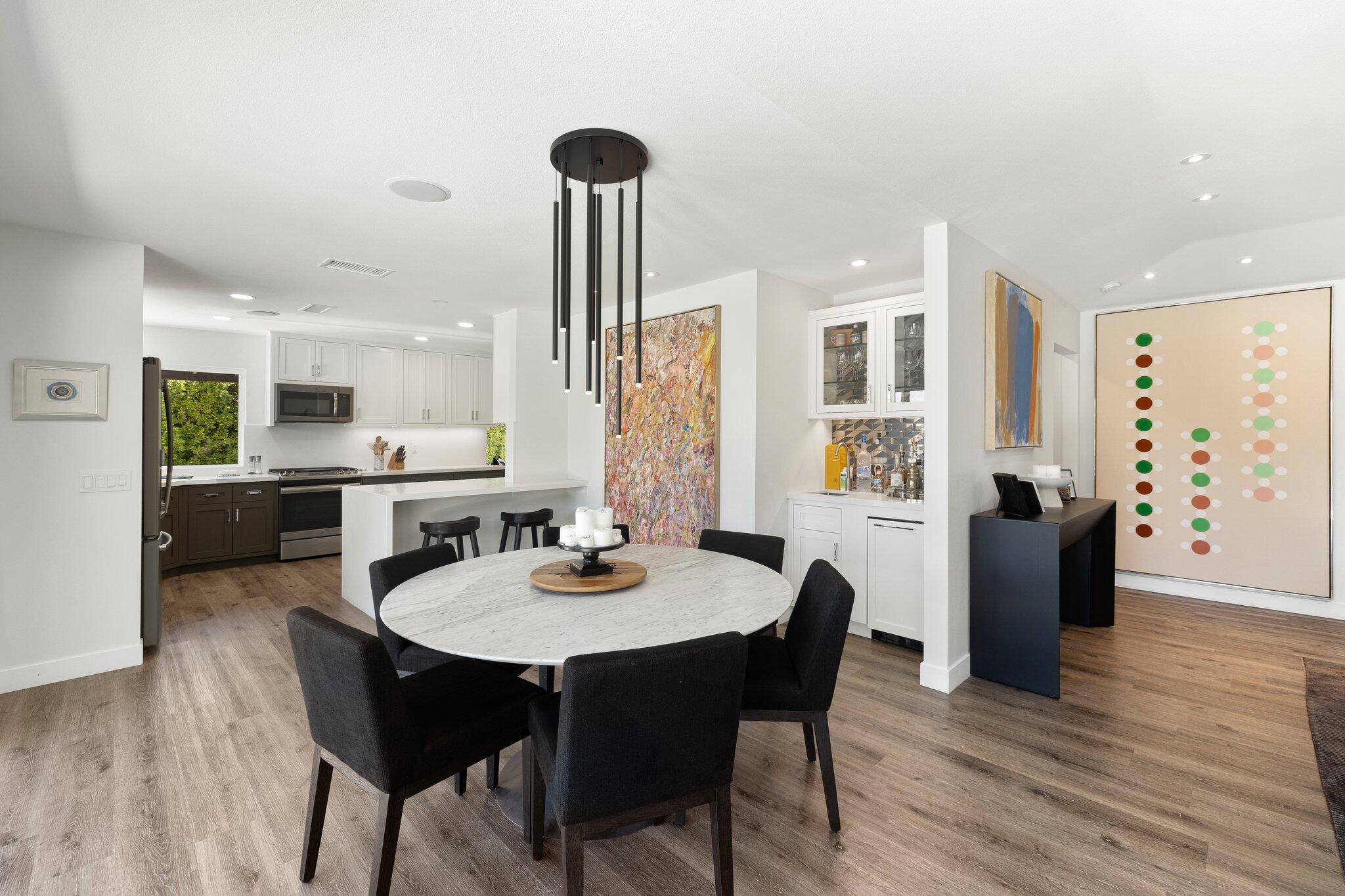 72790 Deer Grass Drive Palm Desert, CA 92260 - Photo 13 of 39 a view of a dining room with furniture and wooden floor