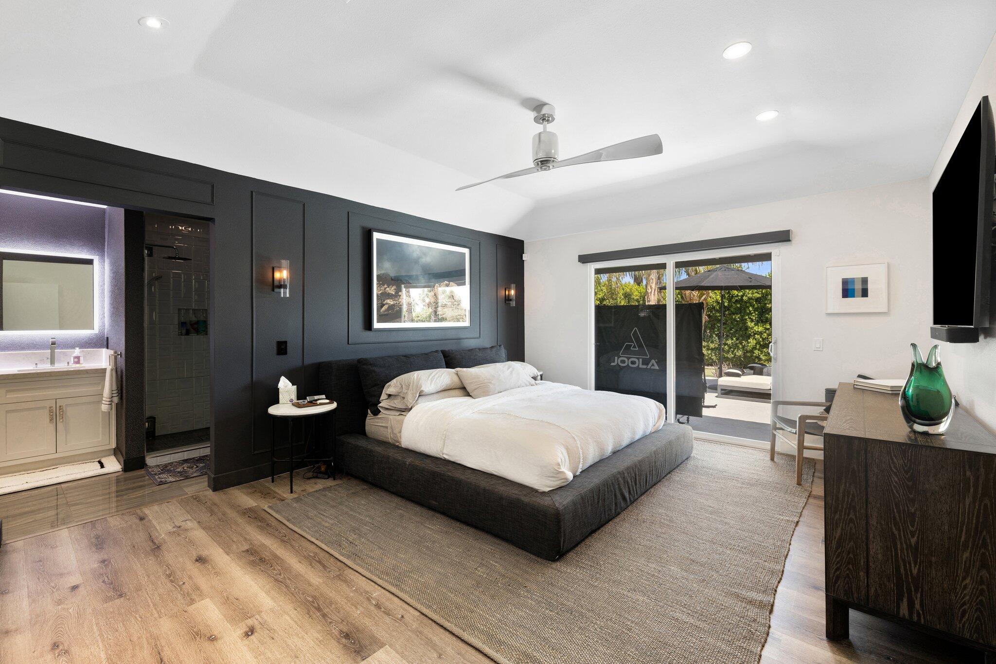 72790 Deer Grass Drive Palm Desert, CA 92260 - Photo 17 of 39 a spacious bedroom with a bed and glass windows