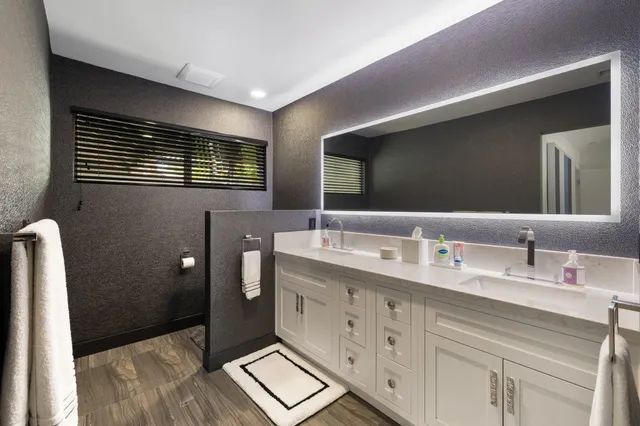 a bathroom with a sink a vanity and a mirror