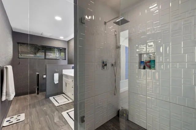 a bathroom with a glass shower door