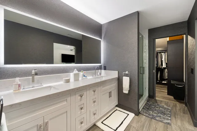 a spacious bathroom with a double vanity sink and a mirror