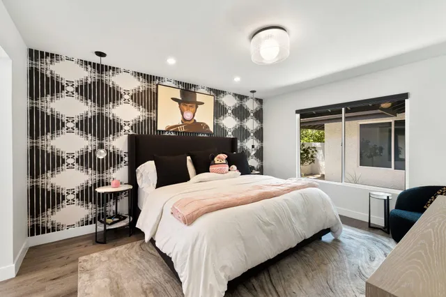 a bedroom with a large bed and a window