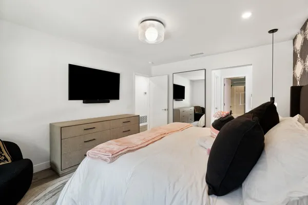 a bedroom with a bed and a flat screen tv