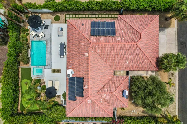 an aerial view of house with yard and outdoor seating