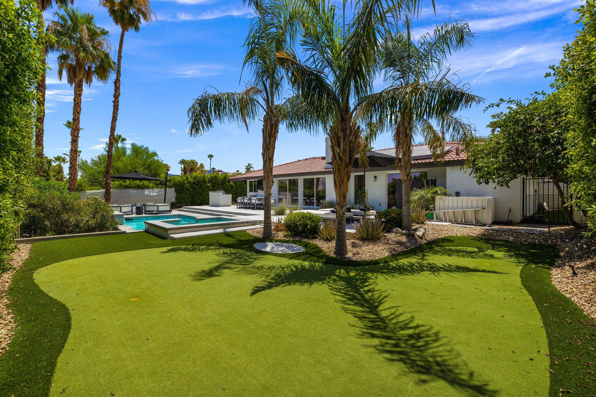 72790 Deer Grass Drive Palm Desert, CA 92260 - Photo 33 of 39 a view of swimming pool with outdoor seating and a garden