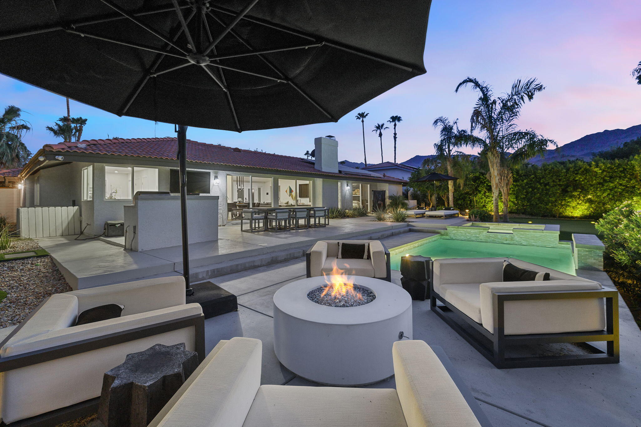 72790 Deer Grass Drive Palm Desert, CA 92260 - Photo 37 of 39 a view of a patio with a table and chairs under an umbrella