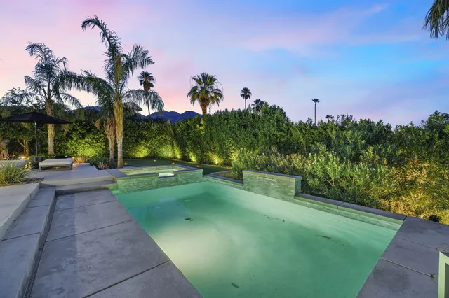 a view of a street with a houses in the background